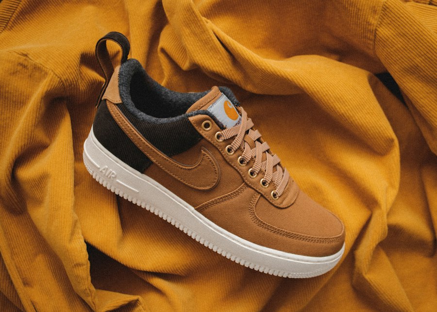 Tan suede Nike sneaker on a mustard fabric backdrop